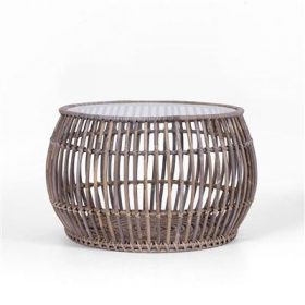 Luna coffee table with glass top and natural weave, set in a relaxed indoor living room.