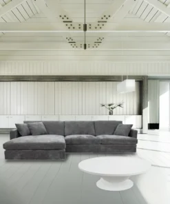 Licorice Brody Fab 2.5 Seater with LHF Chaise, featuring sleek arms and polyester fabric, in a stylish space.