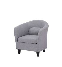 Upholstered armchair with pine frame and high-density foam, displayed in a cozy lounge.