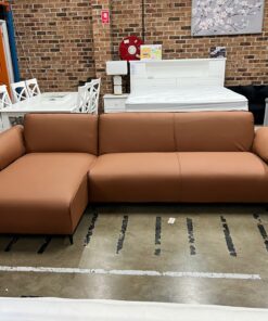 Beige Nile Reversal Sofabed with polyester fabric and versatile design, in a stylish lounge.