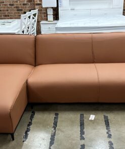 Tan air leather Nile Reversal Sofabed with reversible design, set in a modern living room.