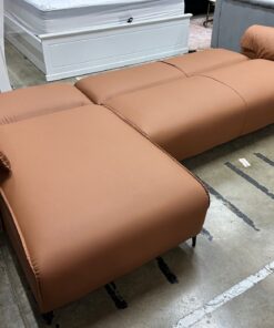 Tan air leather Nile Reversal Sofabed, perfect for small spaces, in a contemporary setting.