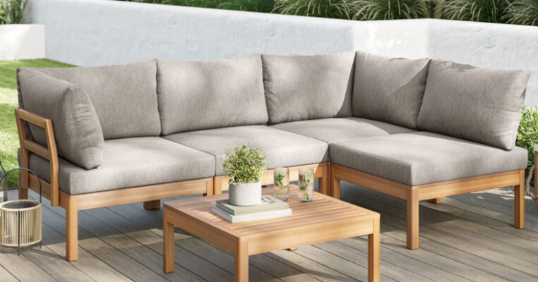 Stylish outdoor modular lounge set with grey cushions on a wooden deck
