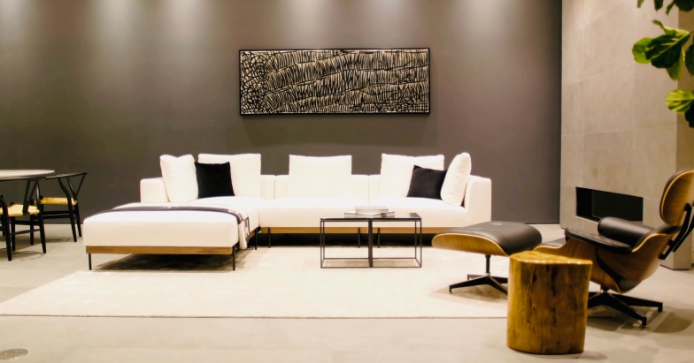 Modern living room setup with a white sectional sofa, accent chairs, and contemporary decor